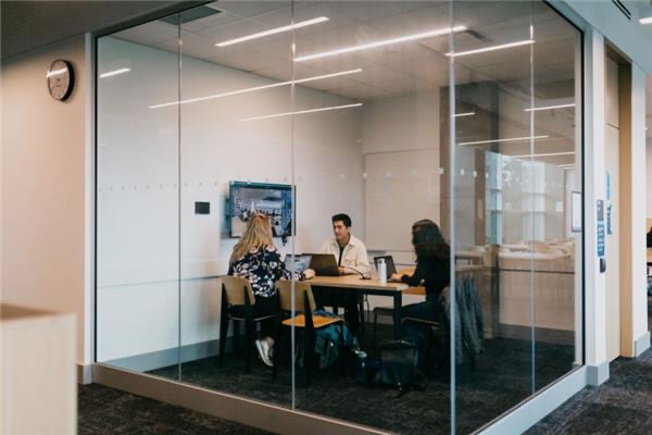 students sitting at a table with computers