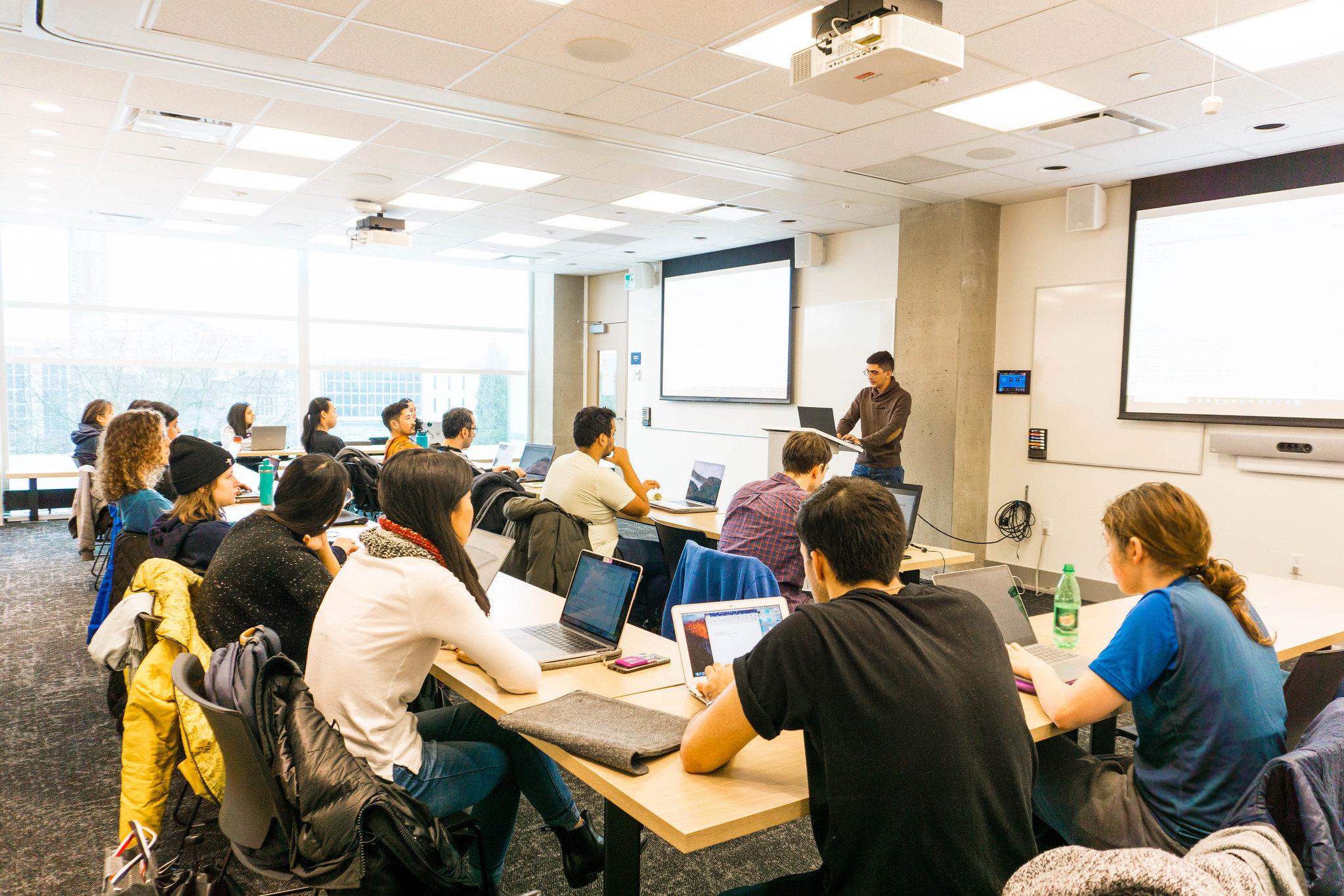 One of the bookable event spaces for graduate events featuring a presenter and a room full of students