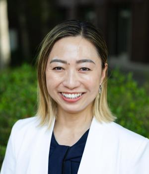 person standing outside in a white shirt