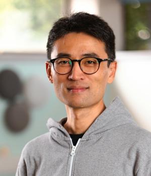 Man wearing glasses and grey hoodie