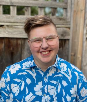 Man wearing blue t-shirt with flower patterns