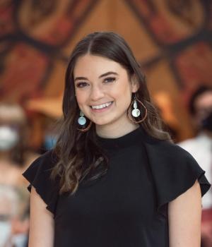 Woman wearing black shirt with earrings