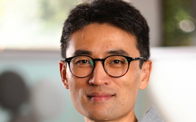 Man wearing glasses and grey hoodie