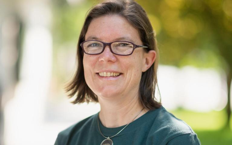 Woman wearing glasses standing outside