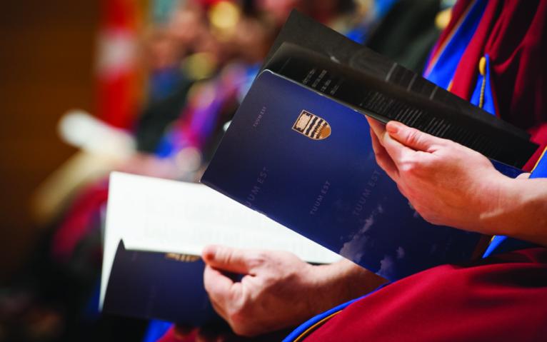 hands holding a diploma