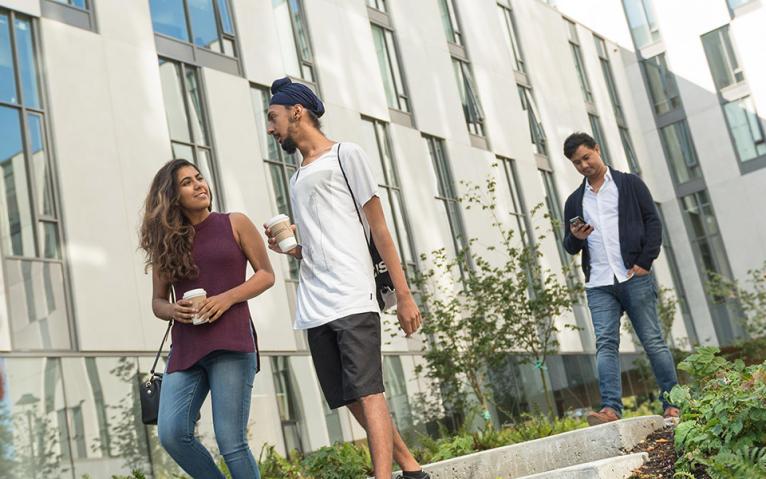 students in front of exterior of residence