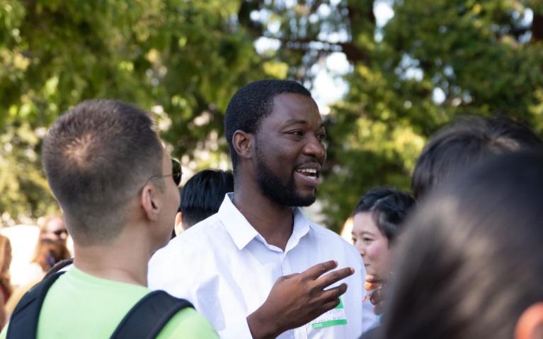 Student talking with other students in a crowd
