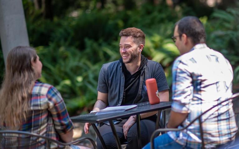 students laughing around a table