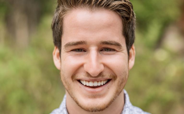 White male with blonde hair in an outdoor setting