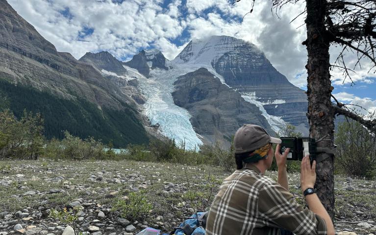 This is a photo of me checking a wildlife camera while assisting a lab-mate with their fieldwork on the Berg Lake Trail in Mount Robson Provincial Park in August 2024.