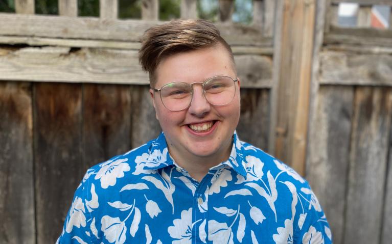 Man wearing blue t-shirt with flower patterns