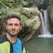 Firth McEachern in front of a small waterfall