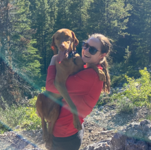 Alysha with their dog on a hike