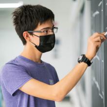 Although I wish most of my time was spent filling chalkboards with wild symbols and equations, most of the time research looks like reading/writing at my desk and making programs on my computer - but I still carry around a case of speciality chalk everywhere I go in case the situation calls for it!