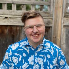 Man wearing blue t-shirt with flower patterns